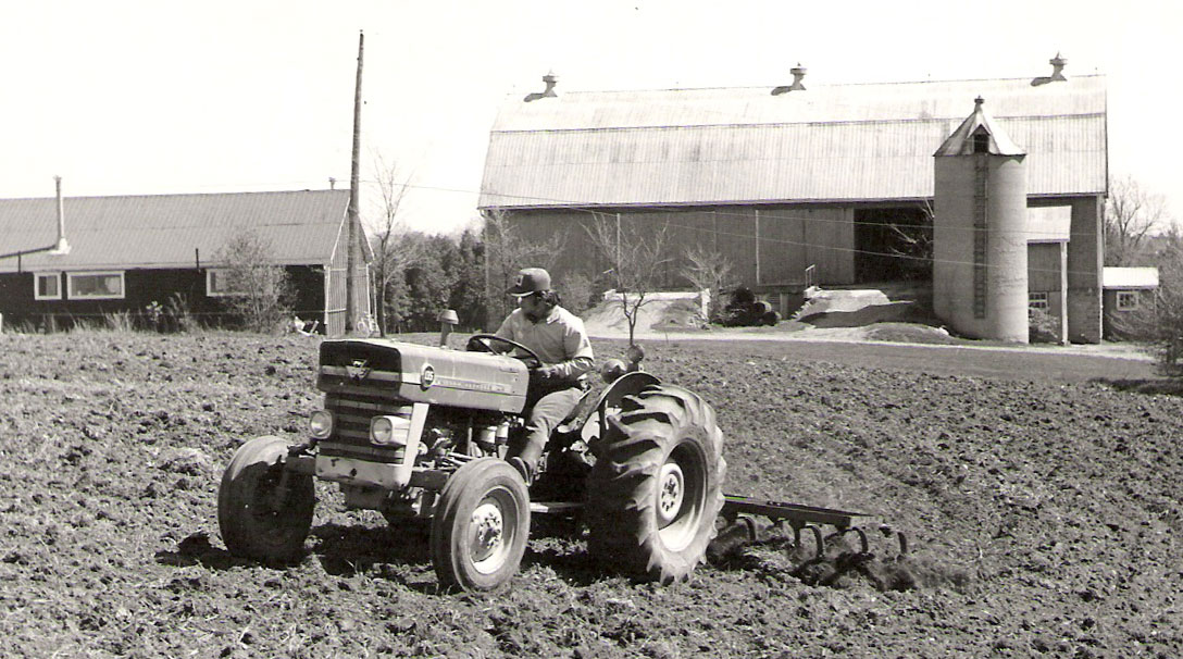 John Smeltzer driving a tractor